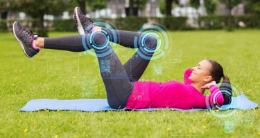 smiling woman doing exercises on mat outdoors